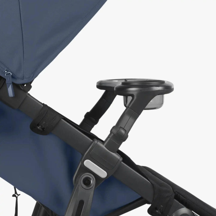 UPPAbaby RIDGE stroller snack tray with integrated cup holder attached to the stroller frame (close-up detail