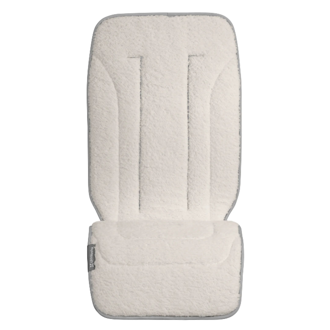 UPPAbaby reversible stroller seat liner in Phoebe, soft cream insert on a white background