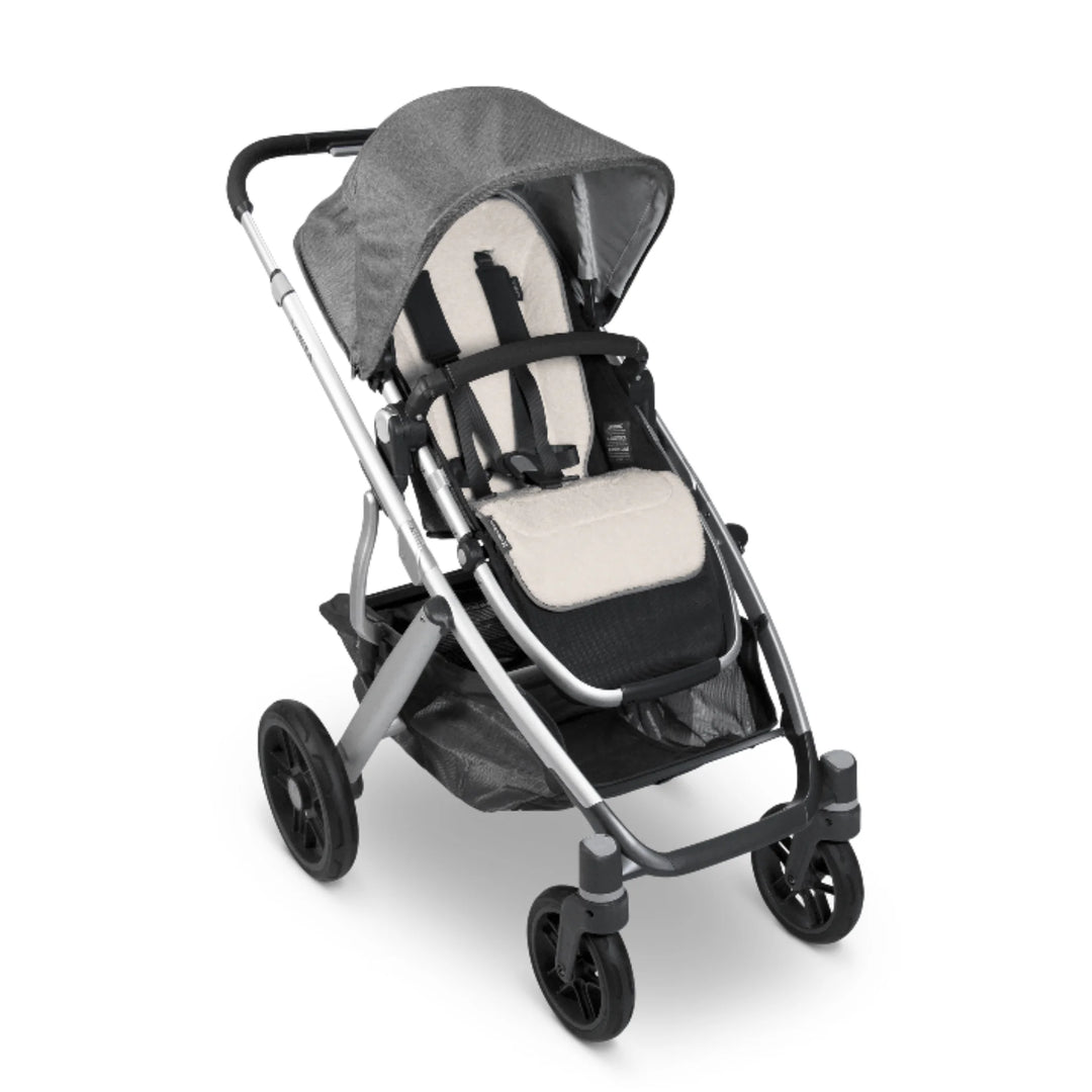 UPPAbaby reversible stroller seat liner in Phoebe fitted in stroller seat, cream seat insert on white background.