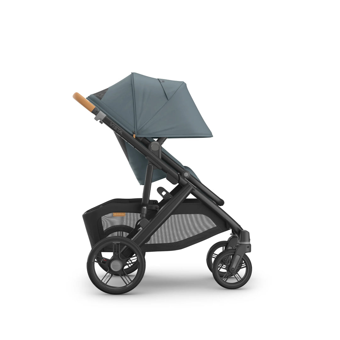 Side view of the UPPAbaby Vista V3 stroller in the Dillian colourway, shown with extended UPF sun canopy, ergonomic leather handlebar, roomy toddler seat and large all-terrain wheels. Premium modular pushchair with oversized under-seat storage basket, displayed on a clean white background.