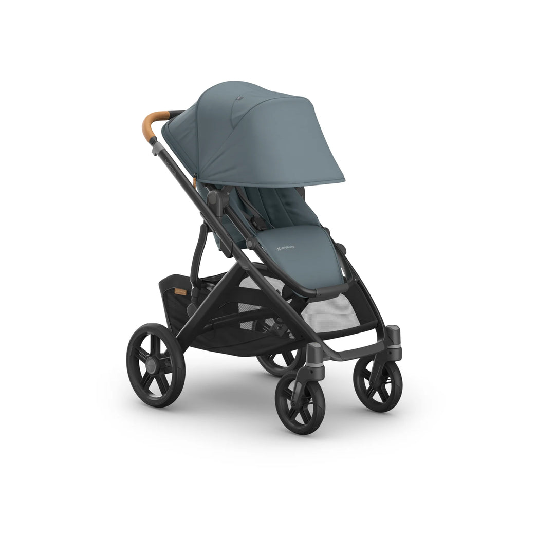 Front-angled view of the UPPAbaby Vista V3 stroller in the Dillian colourway, featuring an extended UPF sun canopy, ergonomic leather handlebar, padded toddler seat, and robust all-terrain wheels. Premium modular pushchair with oversized under-seat storage basket, shown on a clean white background.