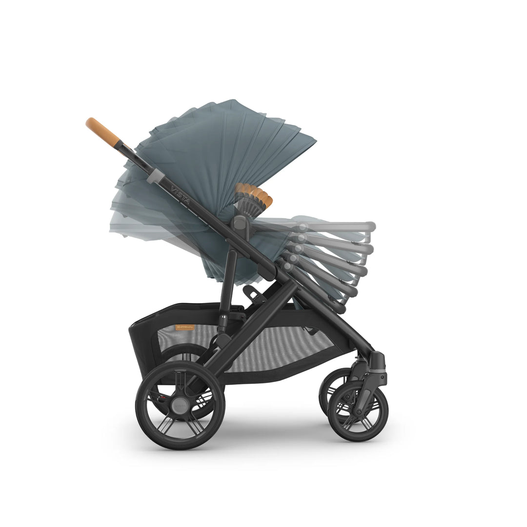 Side view of the UPPAbaby Vista V3 stroller in the Dillian colourway, showing multi-position reclining toddler seat and extendable sun canopy in motion. Demonstrates adjustable seating angles, ergonomic leather handlebar, large all-terrain wheels and oversized storage basket, displayed on a clean white background.