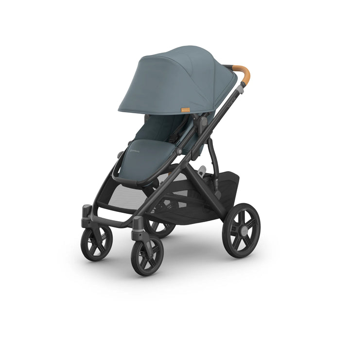 Front-angled view of the UPPAbaby Vista V3 stroller in the Dillian colourway, featuring a fully extended UPF sun canopy, premium leather handlebar, padded toddler seat, robust all-terrain wheels and an oversized under-seat storage basket. High-end modular pushchair design displayed on a clean white background.