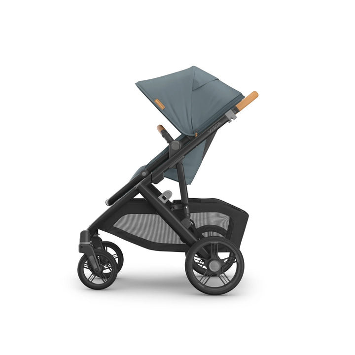 Side view of the UPPAbaby Vista V3 stroller in the Dillian colourway, featuring an extended sun canopy, ergonomic leather handlebar, spacious toddler seat and large all-terrain wheels. Premium modular pushchair with oversized under-seat storage basket, displayed on a clean white background