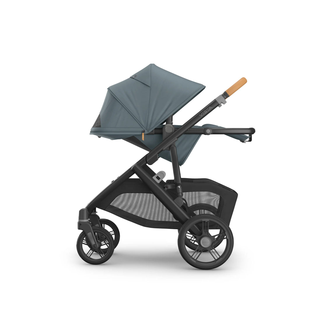 Side view of the UPPAbaby Vista V3 stroller in the Dillian colourway, shown in a fully flat recline position with extended sun canopy, ergonomic leather handlebar, large all-terrain wheels and oversized under-seat storage basket. Premium modular pushchair design displayed on a clean white background.