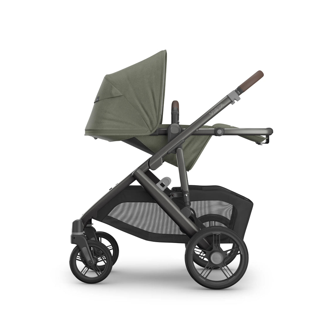 Side profile of the UPPAbaby Vista V3 stroller in the Evelyn colourway, showing the toddler seat in a flat recline with extended UPF sun canopy, premium leather handlebar, durable all-terrain wheels and oversized under-seat storage basket. Luxury modular pushchair displayed on a clean white background.