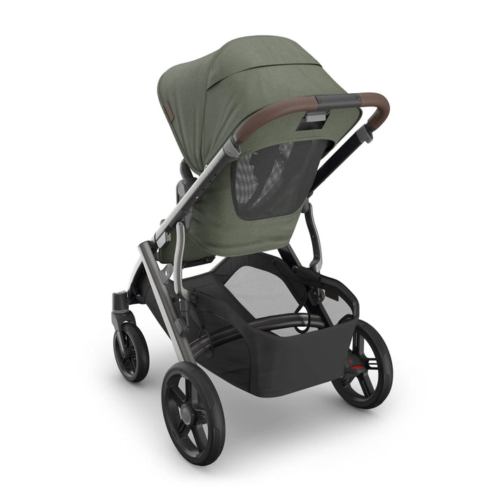 UPPAbaby Vista V3 stroller in green canopy shown from rear angle with mesh ventilation panel, large under-seat storage basket, all-terrain wheels and adjustable leather-accented handlebar.