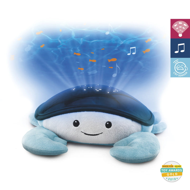 Zazu Cody Ocean Projector – plush blue crab nightlight projecting moving ocean waves and swimming fish with soothing melodies and cry sensor, award-winning baby sleep aid.