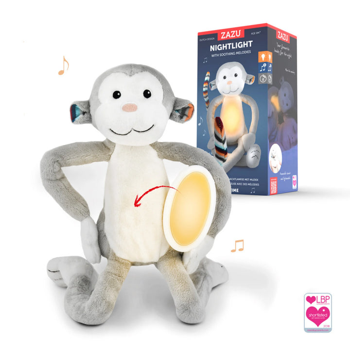 Zazu Max soft toy nightlight plush monkey with glowing removable belly light shown alongside its retail packaging, highlighting soothing melodies, bedtime comfort features and award recognition badge.