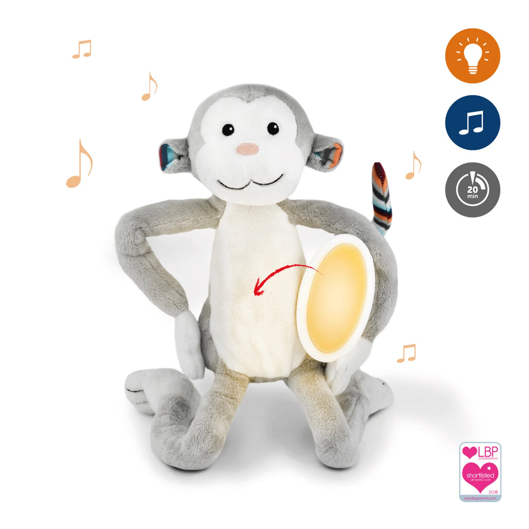 Zazu Max soft toy nightlight plush monkey with warm glowing belly light, musical soothing melodies, 20-minute timer icons, and award badge — calming bedtime comfort toy for babies and toddlers.