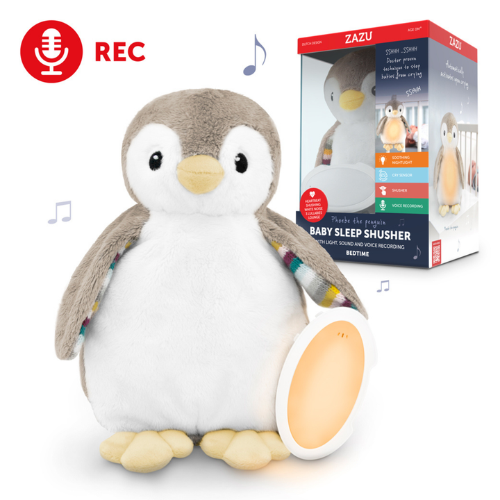 "ZAZU Phoebe penguin baby sleep shusher with nightlight, white noise, and voice recording feature. Plush penguin soother helps babies sleep with lullabies, shushing sounds, and soothing glow. Includes packaging highlighting cry sensor, voice recording, and bedtime comfort features.