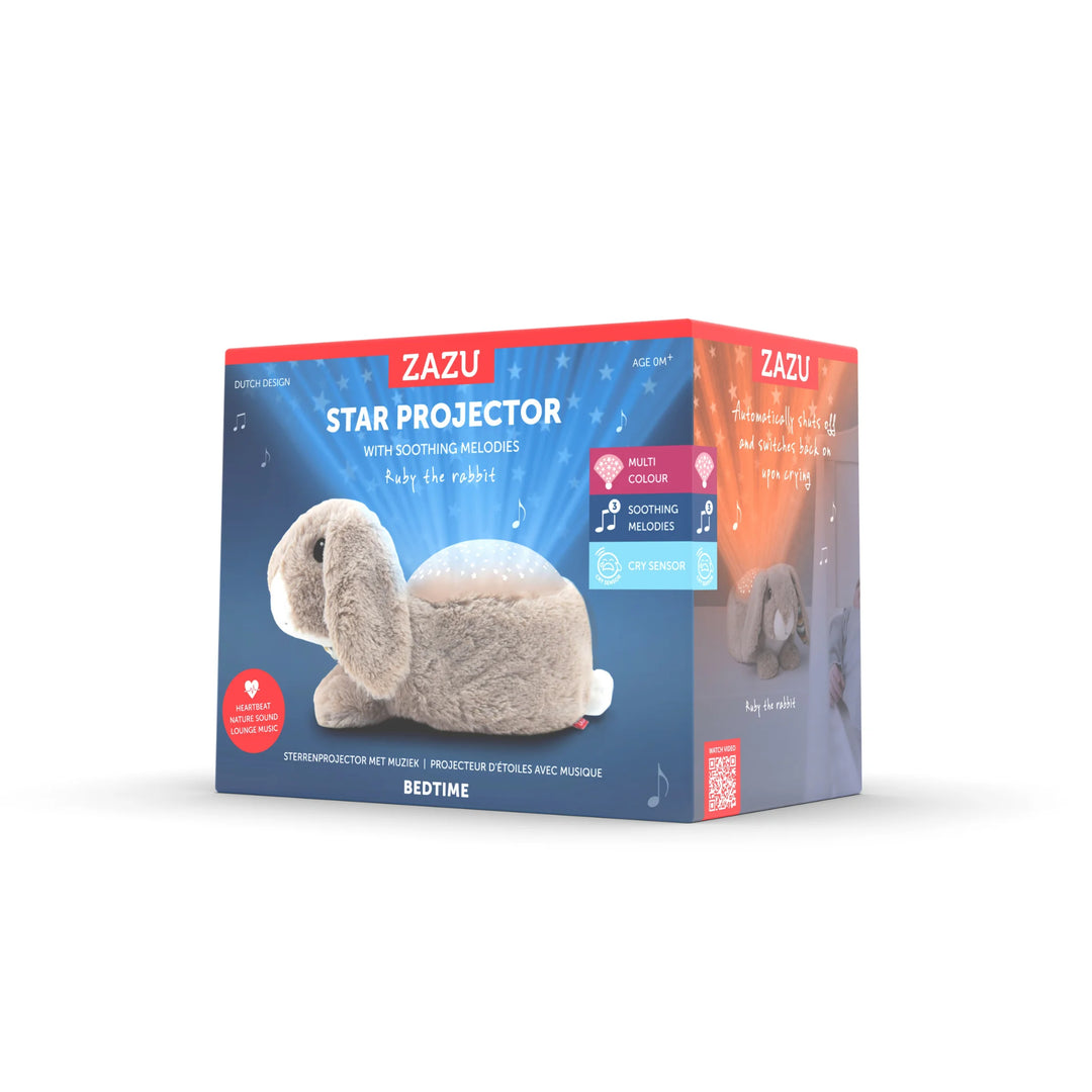Zazu Ruby Star Projector packaging featuring plush bunny nightlight with multicolour star projection, soothing melodies, and cry sensor for calming babies and helping them sleep.