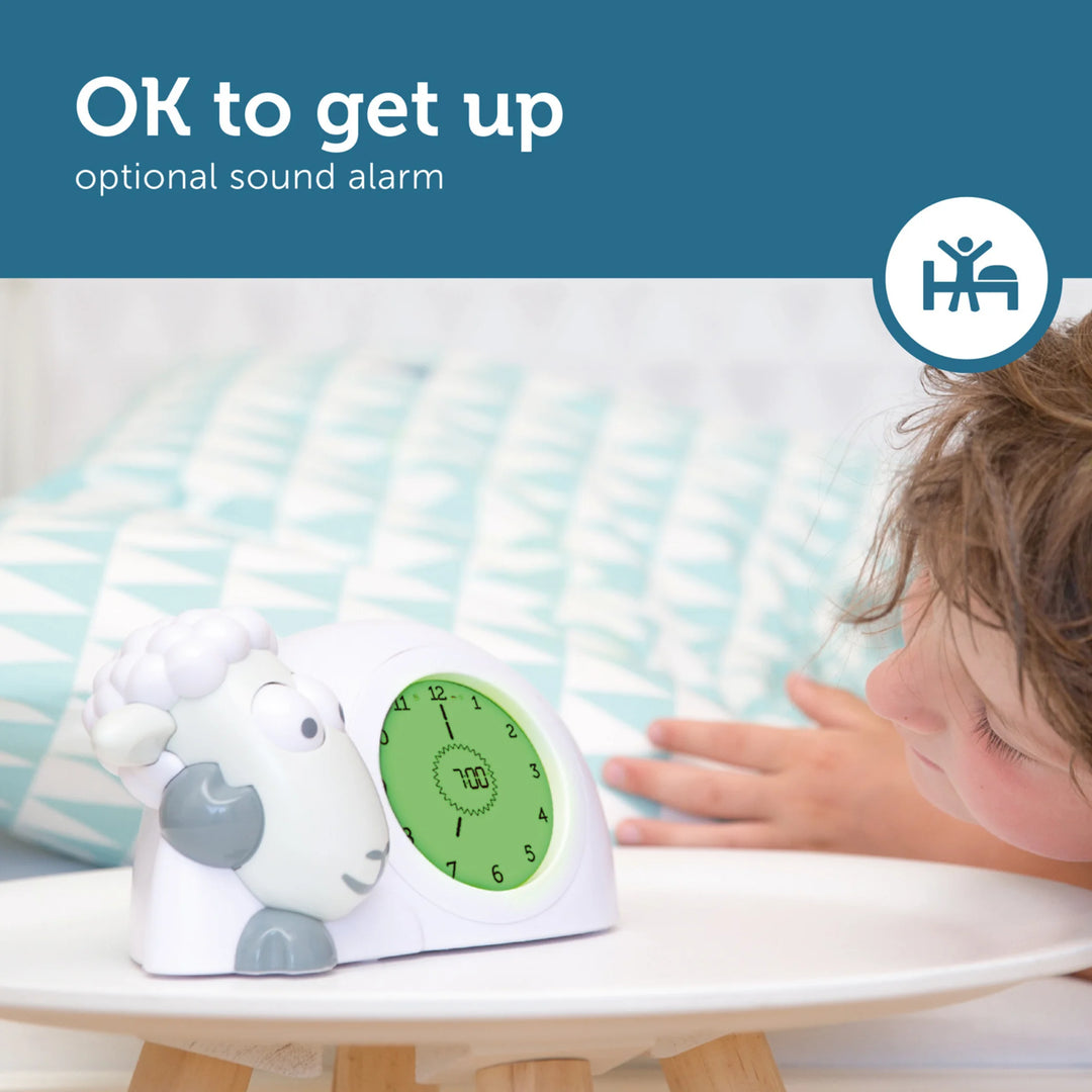 Zazu Sam the Sheep Sleep Trainer clock with green wake-up light and optional sound alarm – child waking up and smiling at the sleep training clock that teaches kids when it’s OK to get up. Ideal toddler alarm clock and sleep aid for healthy morning routines.
