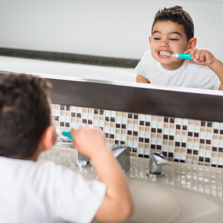BBLuv Sonik electric toothbrush being used by a child in the mirror