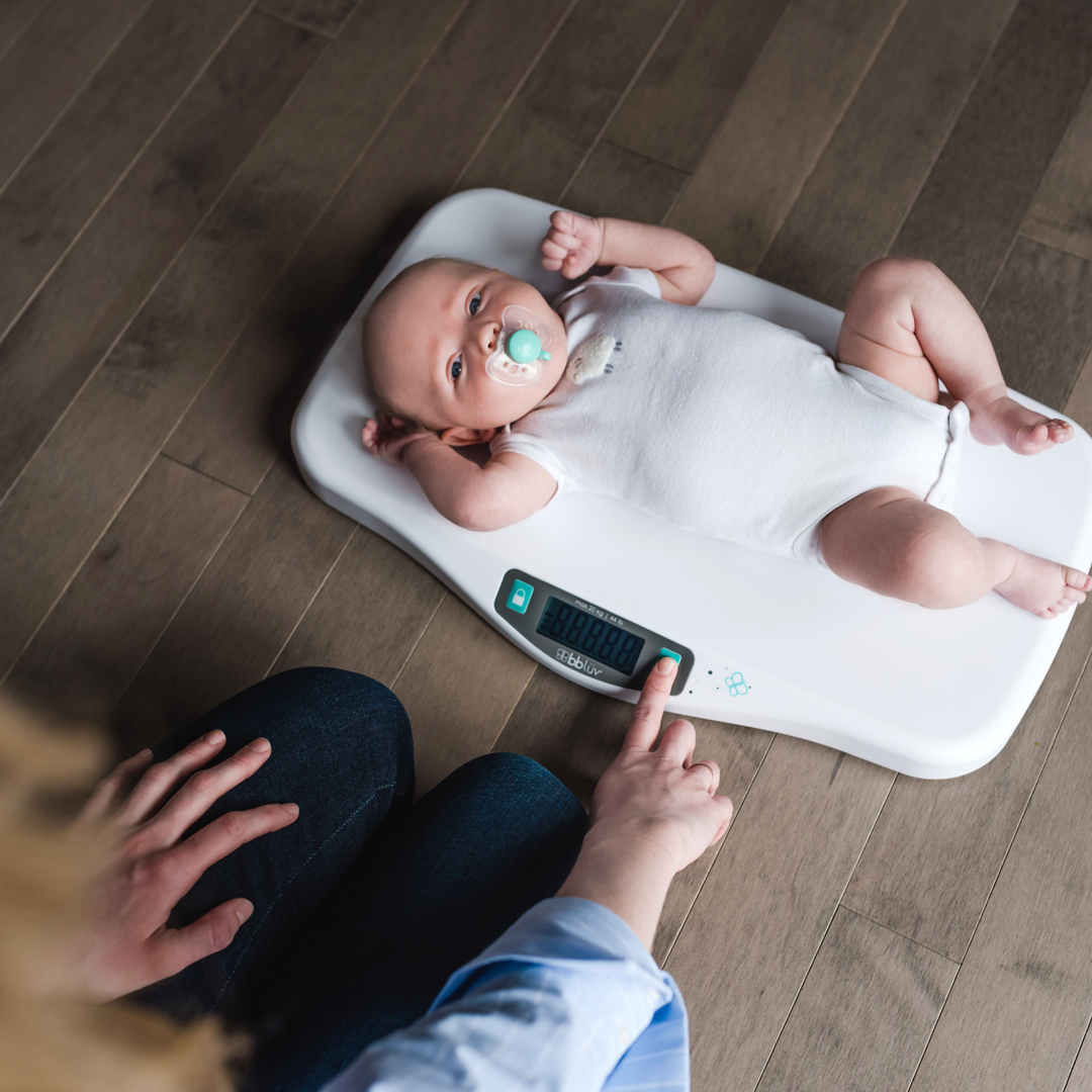 BBLuv Kilo scales being used to weigh a baby while on the floor.