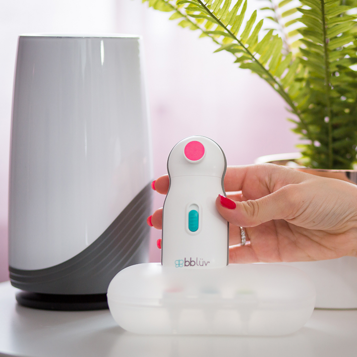 BBLuv Trimo electric nail trimmer standing on handy travel case next to the BBLuv Pure air purifier.