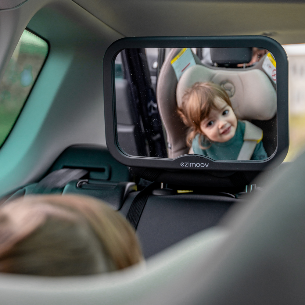 This image shows the square rear car seat mirror from Ezimoov installed on the back seat of a car.