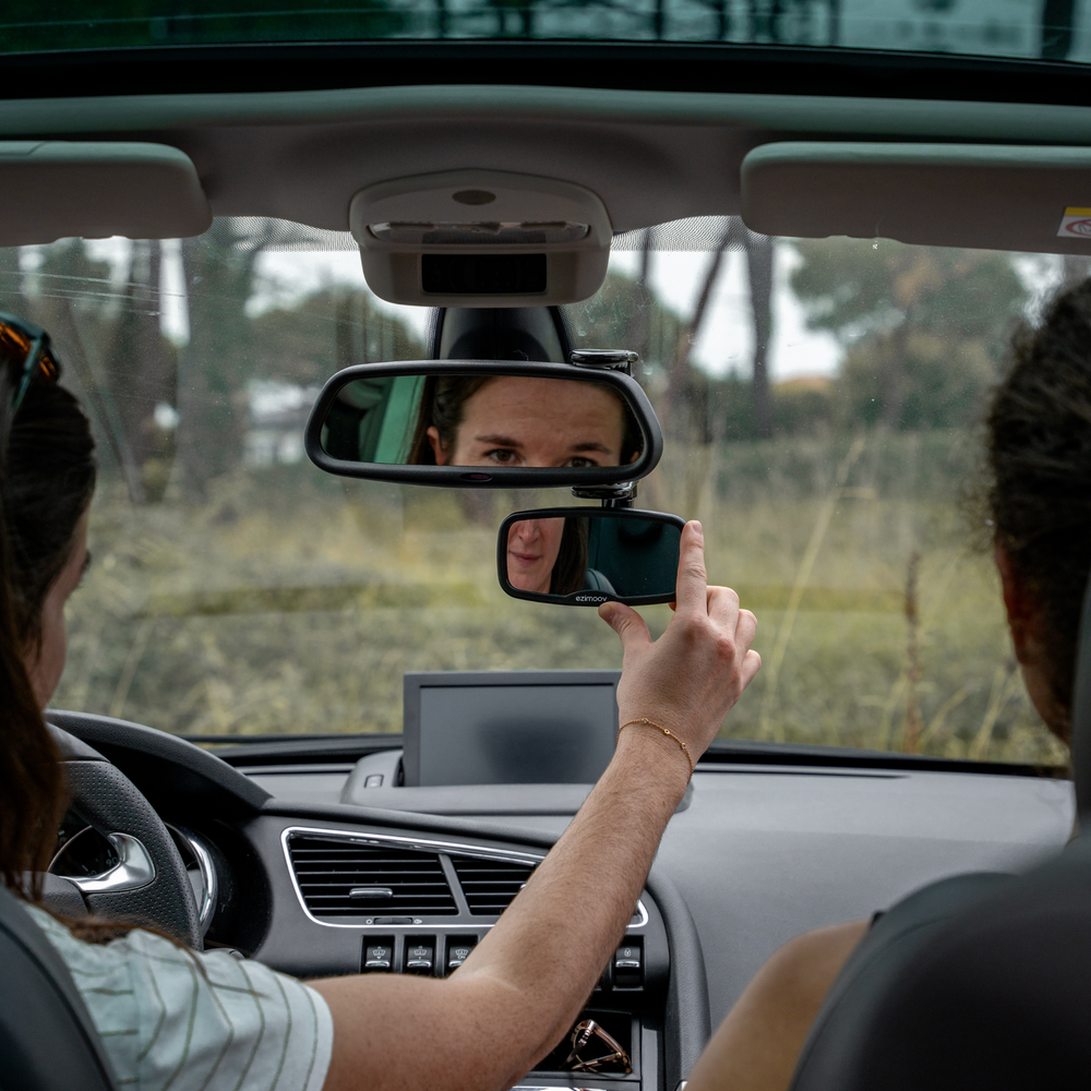 This image shows the Ezimoov Clip-On Rear View Mirror being adjusted by the parent for the perfect view of the back seat.