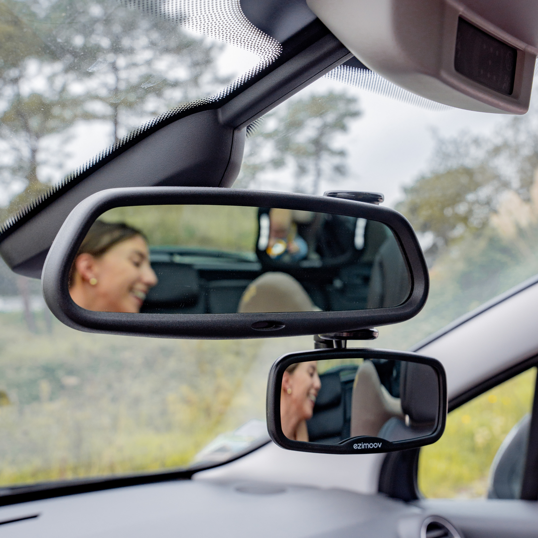 This image shows the Ezimoov Clip-On Rear View Mirror attached to the rear view mirror of the car