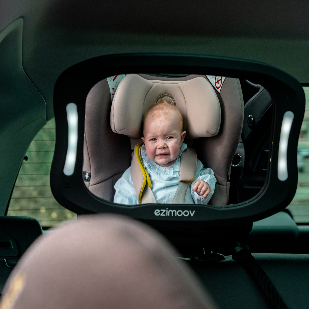 This image shows the LED mirror attached to the headrest of the back seat allowing the parent to see their crying child that are rear facing in their car seat.