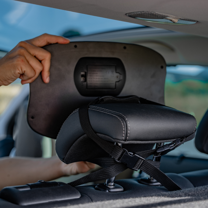 This image shows the mirror being installed and adjusted in the back of the car. You can see the battery slot in the back.