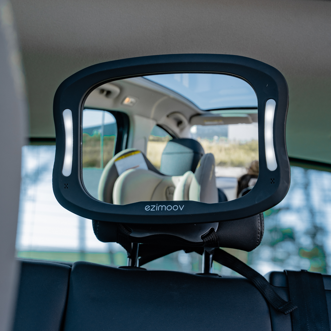 This image shows the LED mirror installed fully with the lights on in the back seat of the parents car.