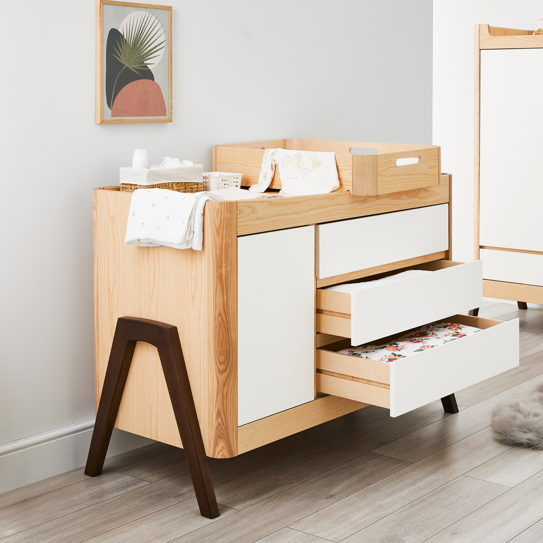 lifestyle image of Gaia Baby Hera Dresser and Hera Changing Station in Natural Ash and Walnut