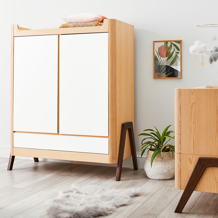 Lifestyle image of Gaia Baby Hera Wardrobe in Natural Ash and Walnut in a room